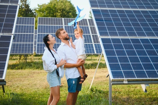 Happy family near solar panels. Alternative energy source photo