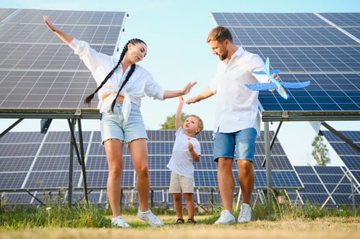 Happy family near solar panels. Alternative energy source photo