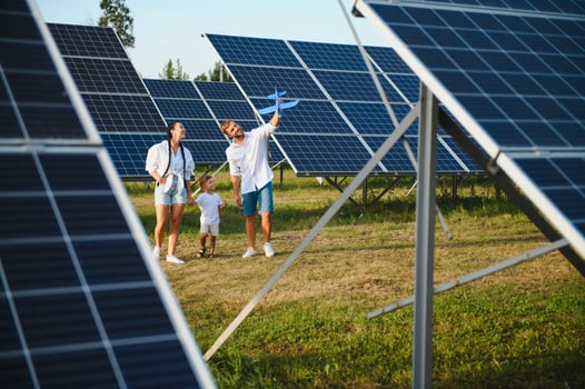Happy family near solar panels. Alternative energy source photo