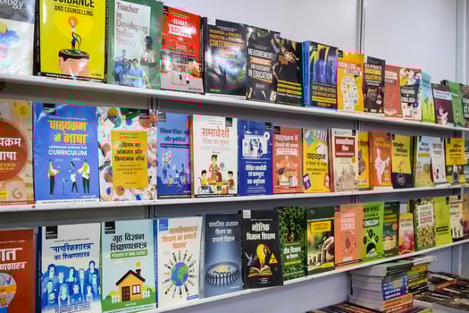 New Delhi, India, February 17 2024 - Variety of Books on shelf inside a book-stall at Delhi International Book Fair, Selection of books on display in Annual Book Fair at Bharat Mandapam complex photo