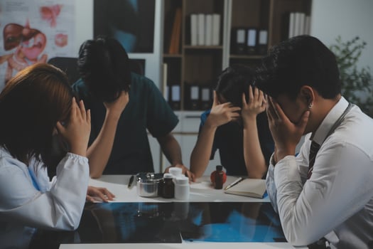 Manager Man Checking Pie Chart Data of Monthly Audit Report and Give a Negative News to his Medical Team in Hospital Boardroom Office or Healthcare Centre Meeting Room photo