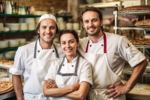 Smiling chefs team in bakery photo