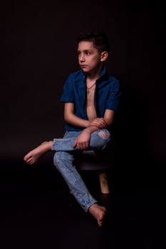 boy posing on a black background . close-up photo