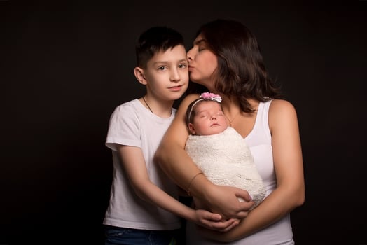 mom son and daughter on a black background photo