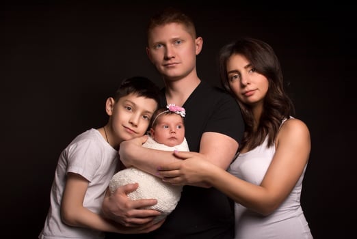 Family portrait on a black background. mom dad daughter and son. photo