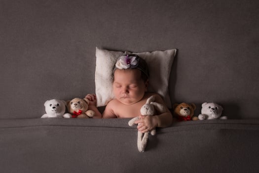 newborn baby sleeps, lies on a gray background photo