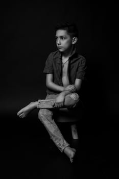 boy posing on a black background . close-up photo