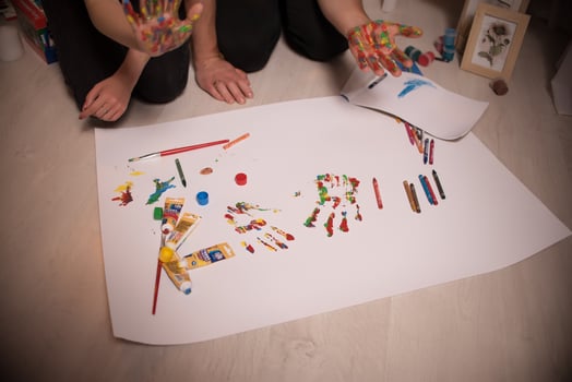 Two lovers draw with paints. Two lovers draw with paints. Hands are covered with paint . photo