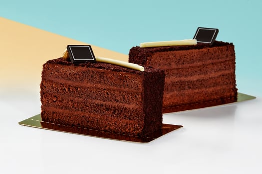 Chocolate cake slices coated with streusel against pastel background photo