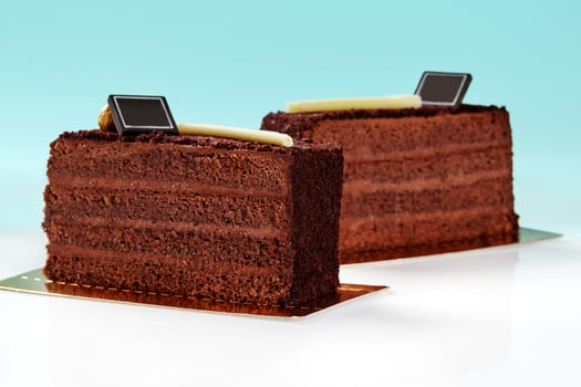 Slices of chocolate cake topped with crunchy streusel on blue background photo