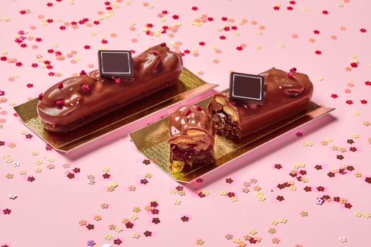 Milk chocolate bars on shortcrust cookies with fruit jelly and pecans photo