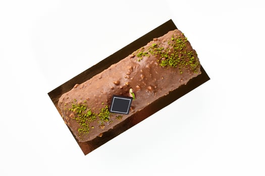 Artisanal chocolate and nuts glazed loaf cake with pistachio crumble photo