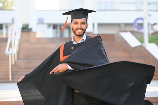 portrait of successful indian student in graduation gown. photo
