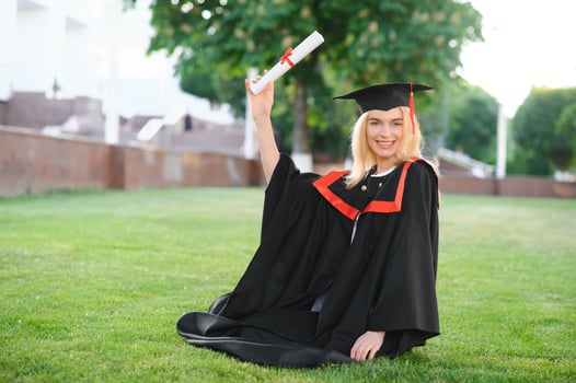 A young female graduate against the background of university. photo