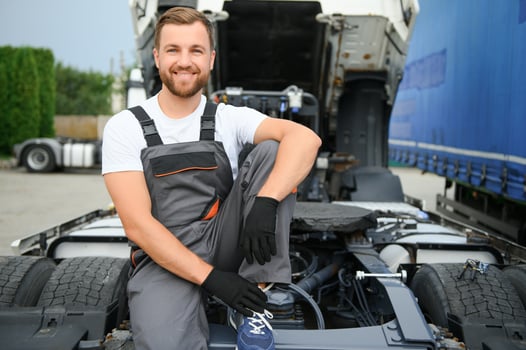 Professional truck mechanic working in vehicle repair service. photo