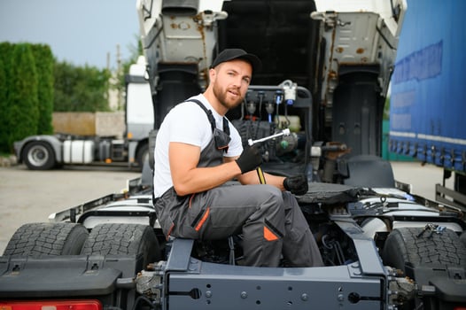 Semi Truck Maintenance. Caucasian Truck Service Worker in His 30s Performing Scheduled Recall Maintenance. photo