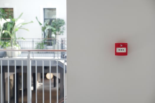 Red fire alarm button on wall , photo