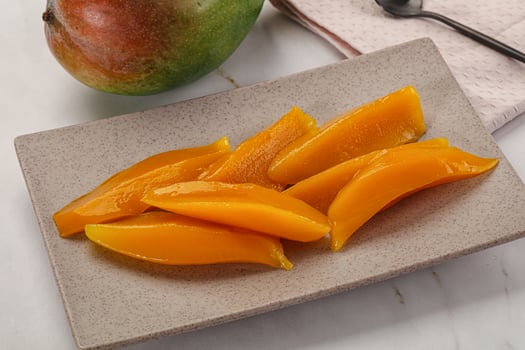 Canned mango slices in the bowl photo