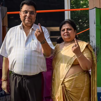 New Delhi, India - May 25 2024 - Unidentified people showing their ink-marked fingers after casting votes in front of polling booth of east Delhi area for general Lok Sabha Elections 2024 photo
