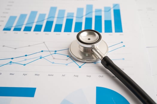 Stethoscope on spreadsheet and graph paper, Finance, Account, Statistics, Investment, Analytic research data economy and Business company concept. photo