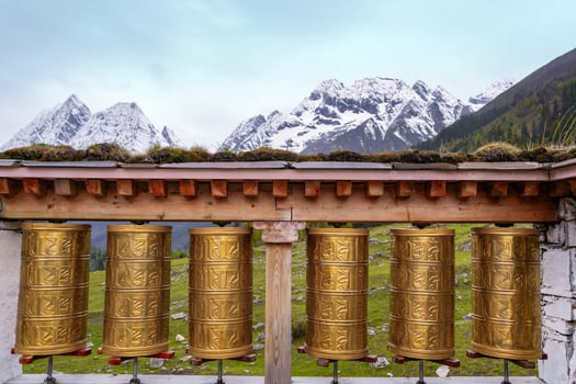 tibetan prayer wheels with snow mountian on background photo
