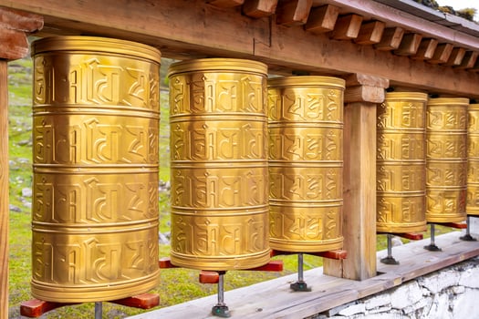 tibetan golden prayer wheels at temple photo
