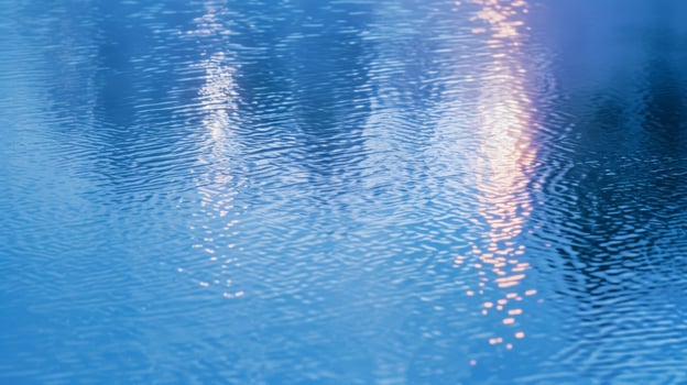 The soft blue light of St. Elmos Fire reflecting off the still waters of a lake photo