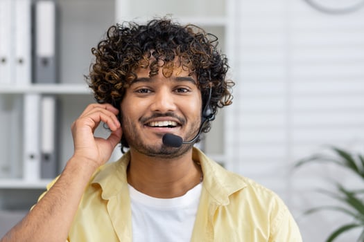 Smiling customer service representative wearing a headset in a modern office, ready to assist clients. photo