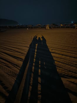 Shadow of my happy family, on the sand, at the night photo