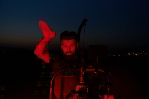 Nighttime Capture. Professional Videographer Films Athletes Running in Red-Lit Darkness photo