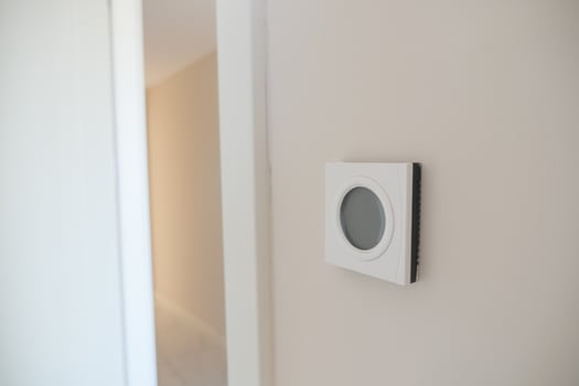 Smart Thermostat on White Wall for Optimal Home Temperature Control photo
