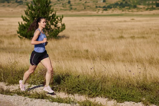 A determined woman athlete trains for success in the morning sun. photo