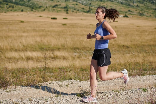 A determined woman athlete trains for success in the morning sun. photo
