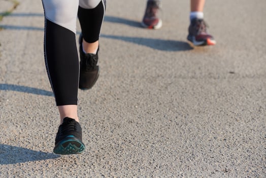 Close-Up. Athletic Runner's Legs Captured in Action on a Sunny Day. photo