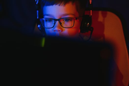 Boy in the headphones is playing a game. photo