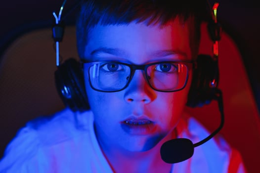 Boy in the headphones is playing a game. photo