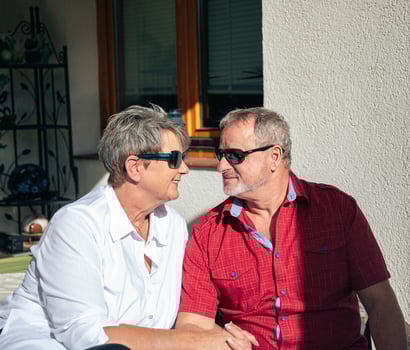 Senior Couple with Sunglasses Sharing a Warm Glance in the Sunshine photo