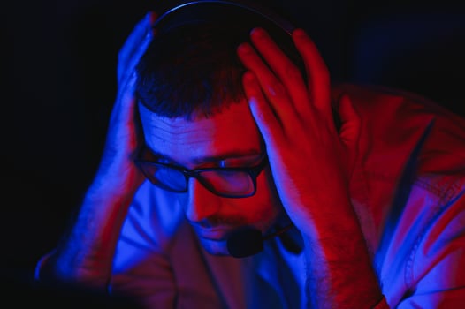 young man playing computer games on line photo