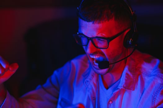 young man playing computer games on line photo