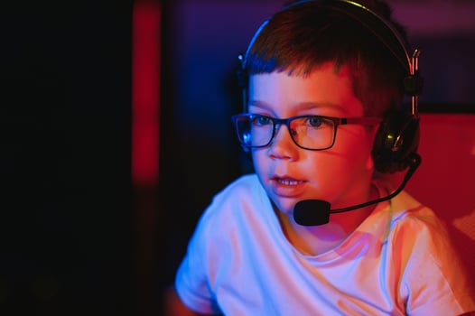Boy in the headphones is playing a game. photo
