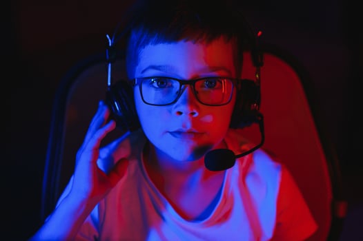Boy in the headphones is playing a game. photo