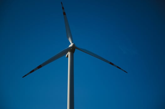 Wind Turbines in a Green Field and Blue Sky. photo