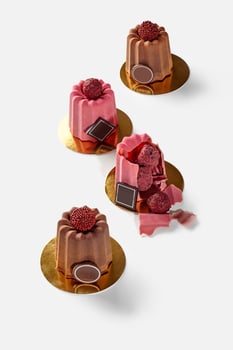 Brittle Belgian chocolate shells with truffle candies on white photo