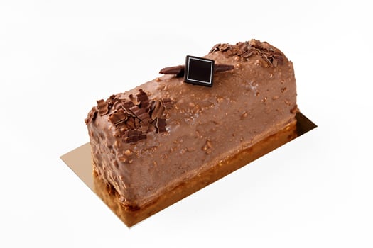 Artisanal loaf cake coated with milk chocolate and nuts glaze photo