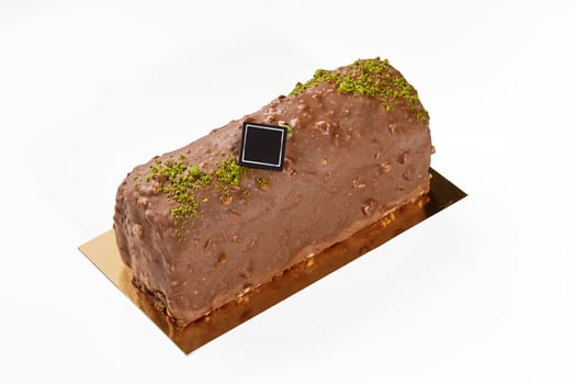 Handcrafted chocolate glazed loaf cake with pistachio crumbs photo
