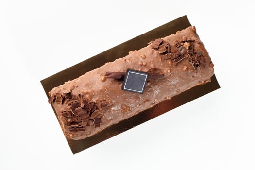 Artisan chocolate glazed loaf cake with hazelnut crumbs photo