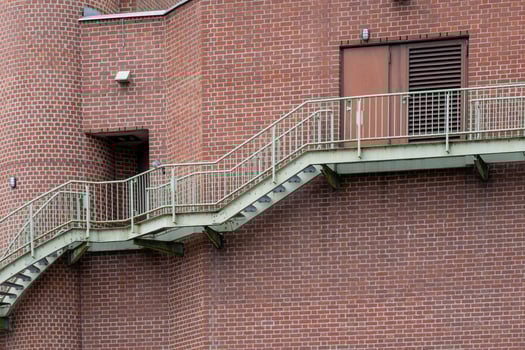 external steel staircase on a brick wall photo