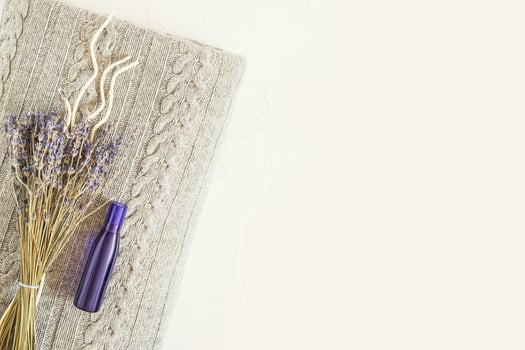 Cozy home banner with a knitted blanket, lavenders, aroma sticks and oil photo