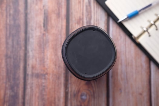 smart speaker and notepad on wooden table. photo