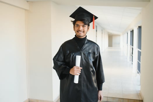 Emotional indian graduate in graduation glow and diploma. photo